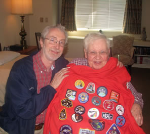 Photo of brother holding hoodie of NASA patches up to Dad